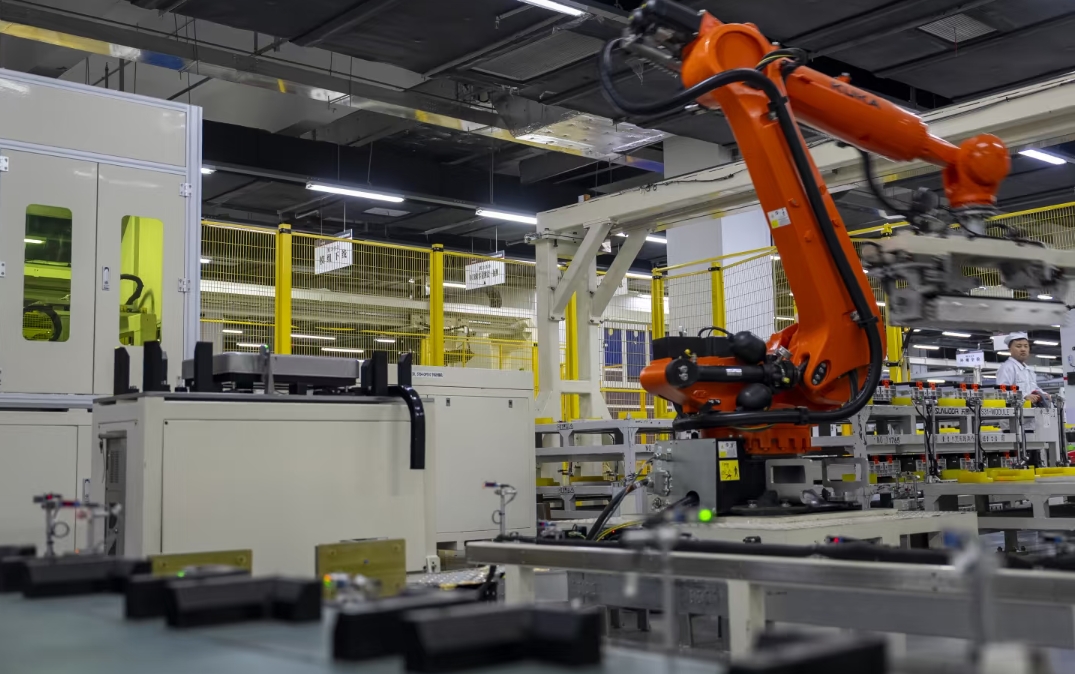 Robotic arm operating on an automated components production line in a Chinese factory
