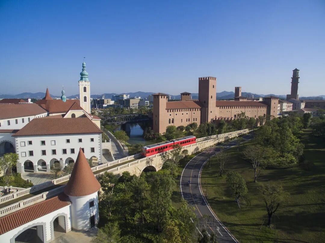 Aerial view of Huawei Ox Horn Campus in Dongguan with the internal commuter train crossing a viaduct between campus blocks