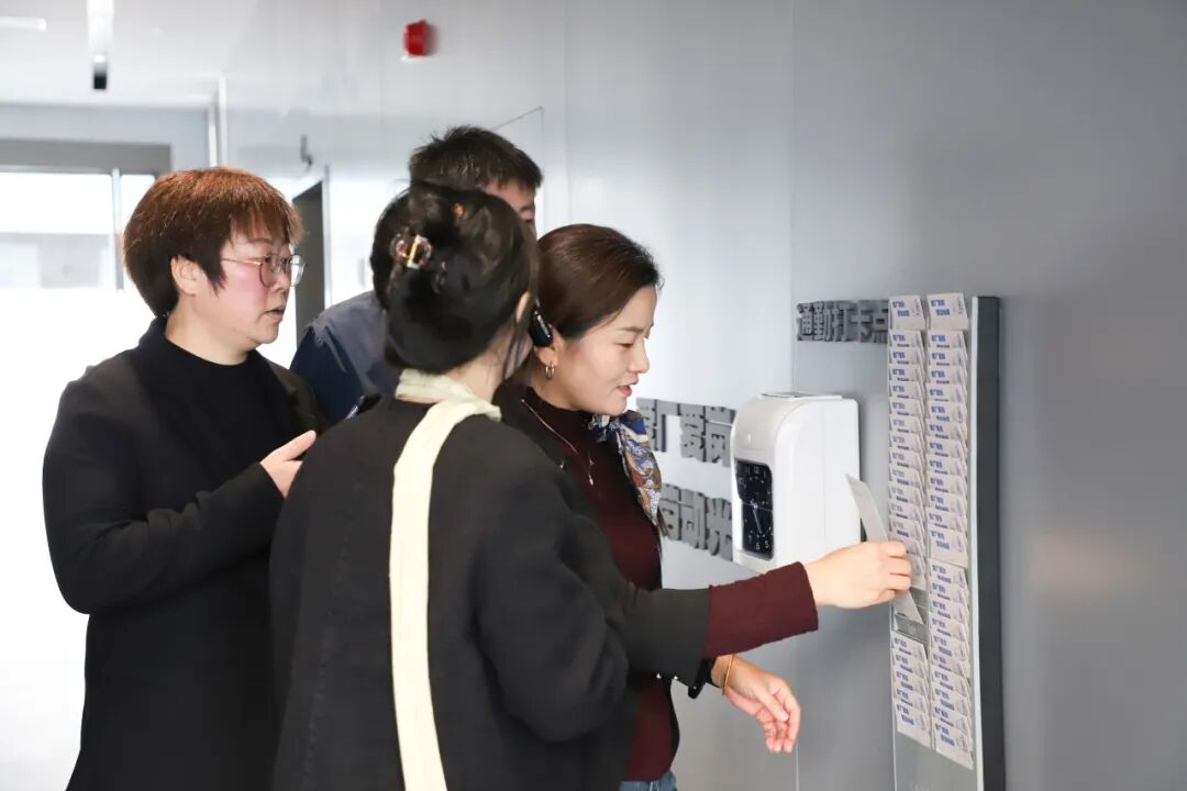 Old punch-clock machine at the entrance of BYD Building 6, Floor 1 — the starting point of the BYD factory tour