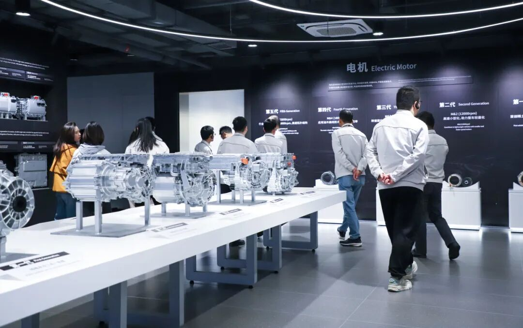 BYD Building 7 exhibit showing the four industries — autos, electronics, new energy, and rail transit — advancing in parallel