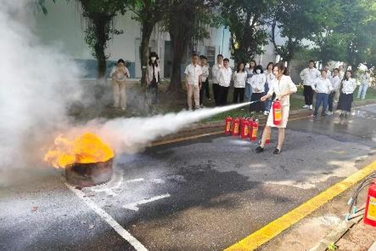 GAC safety-management course participants practicing a fire-extinguisher drill outdoors