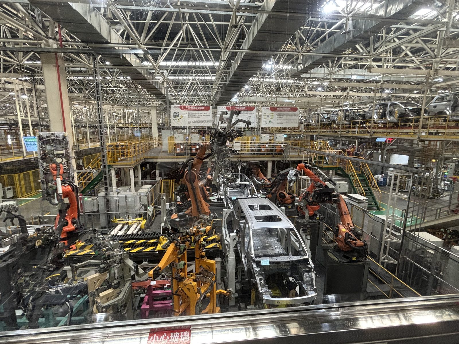 Robot arms welding car bodies on the underbody line at GAC Trumpchi's Guangzhou plant