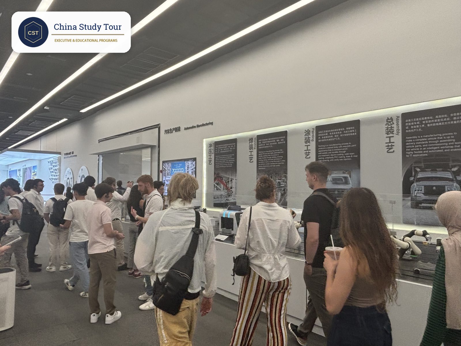 Visitors at the Automotive Manufacturing exhibit inside the BYD Shenzhen exhibition hall, covering stamping, welding, painting and assembly