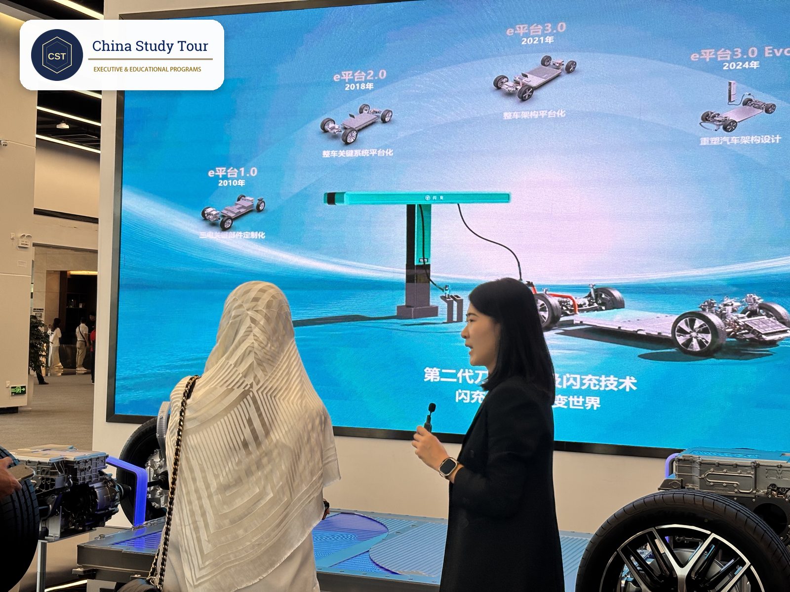BYD exhibition screen showing e-Platform 1.0 to 3.0 Evo above a model of the second-generation Blade Battery and megawatt flash charger