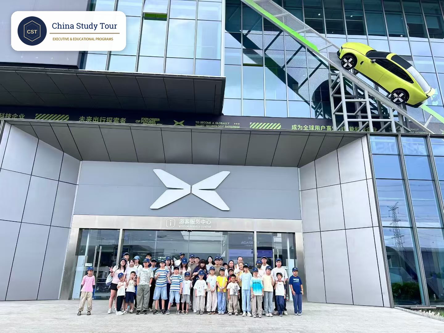 China study tour safety for schools: a student group in matching caps outside the visitor center of a Chinese EV maker