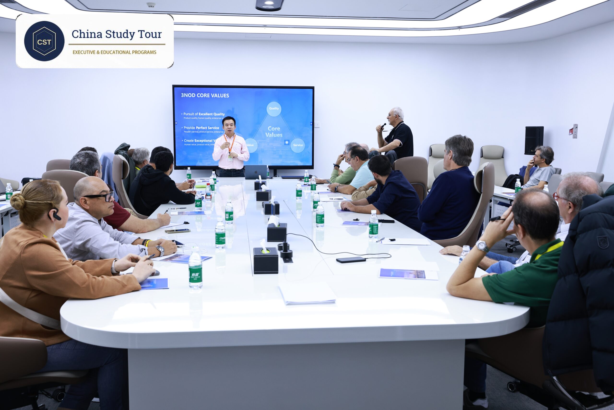 China company visit vs tourist trip: a group inside a company facility with a professional guide