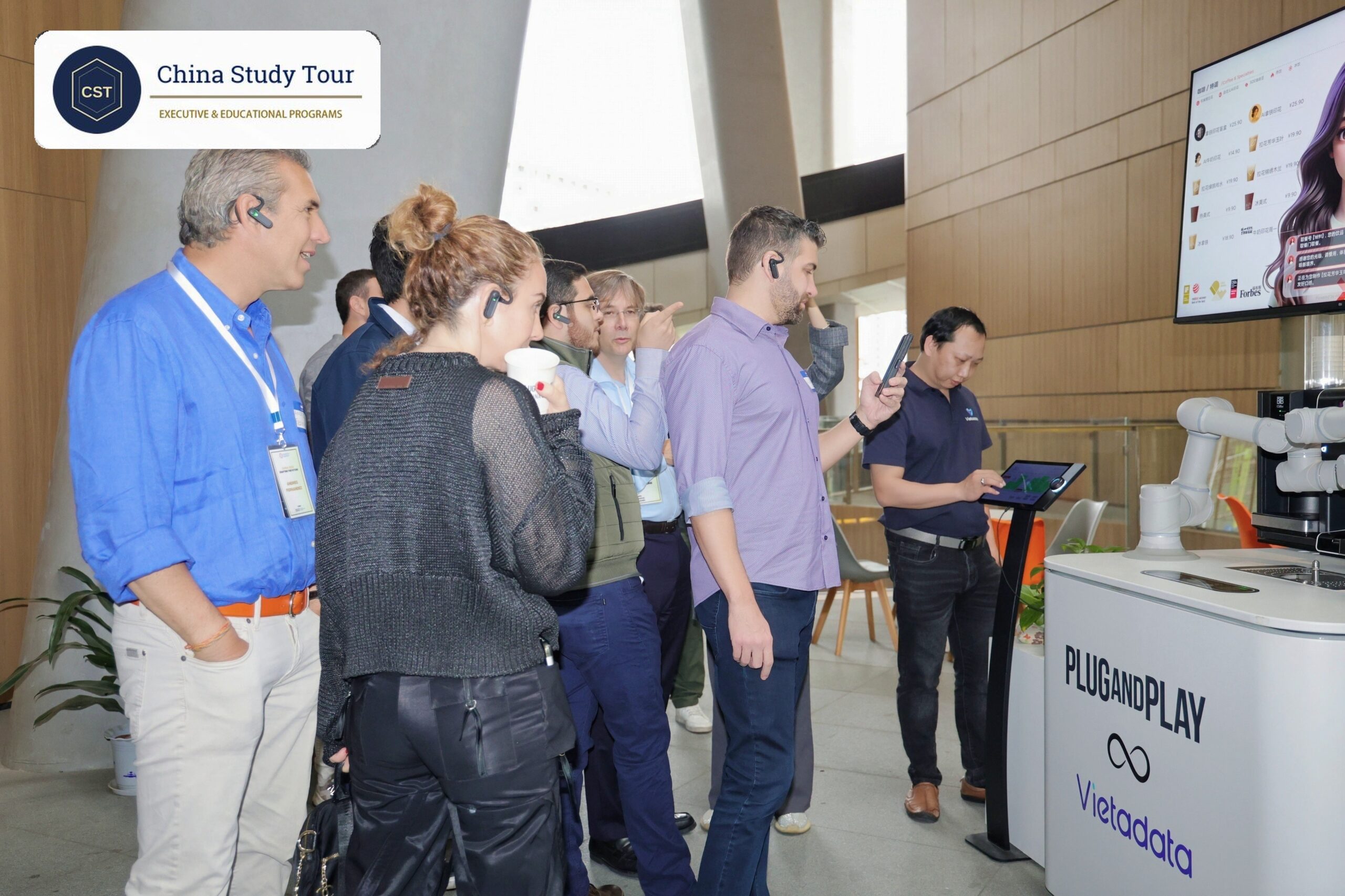 Organized study tour vs independent trip in China: a guided company visit with a host explaining to the group